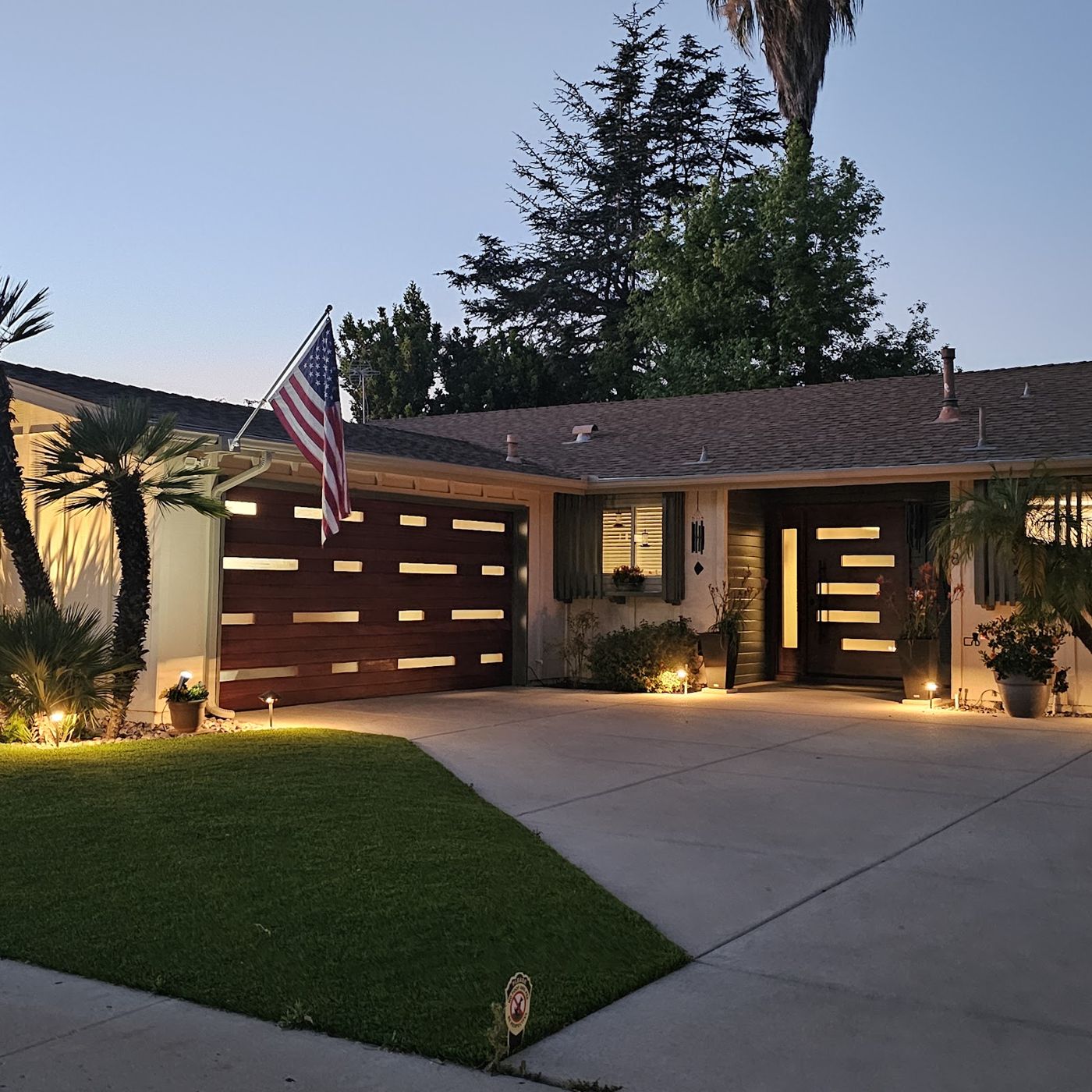 Modern wood-look garage door on a home at dusk