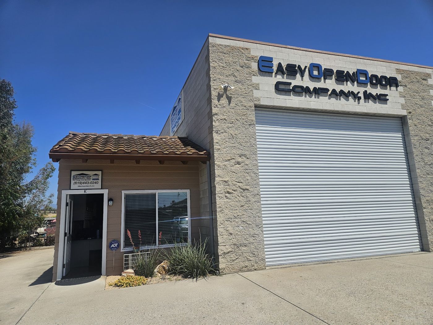 Easy Open Door Company shop on Woodside Ave in Lakeside, with its roll-up door and sign